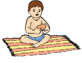 A child is sitting on a mat and eating a bun.
