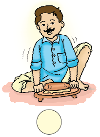 A man is rolling pooris on a board with a rolling pin.