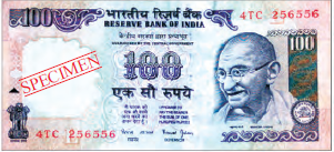 A hundred rupee note, it is rectangular in shape. It has pictures of Mahatma Gandhi, our national emblem and in the middle, number hundred is written.