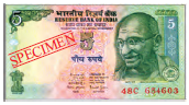 A five rupee note, it is rectangular in shape. It has pictures of Mahatma Gandhi, our national emblem and in the middle, number five is written.