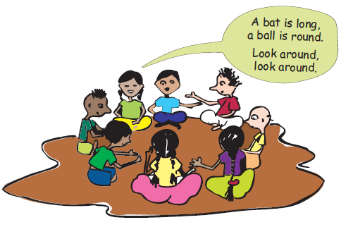 Some children are sitting in a circle in the class, they are clapping and singing and a girls is saying– A bat is long, a ball is round. Look around, look around.