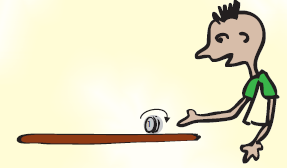 A boy is spinning a coin on a flat surface.