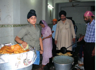 People in the kitchen of a Gurudwara. 