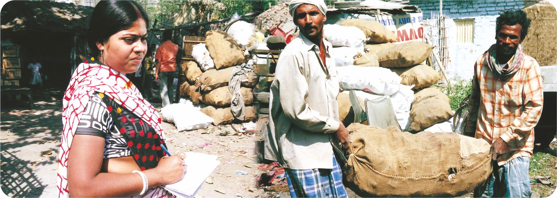 Two men lifting a big sack and the woman  is standing next to them. 