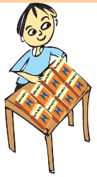 A boy arranging books on a table.