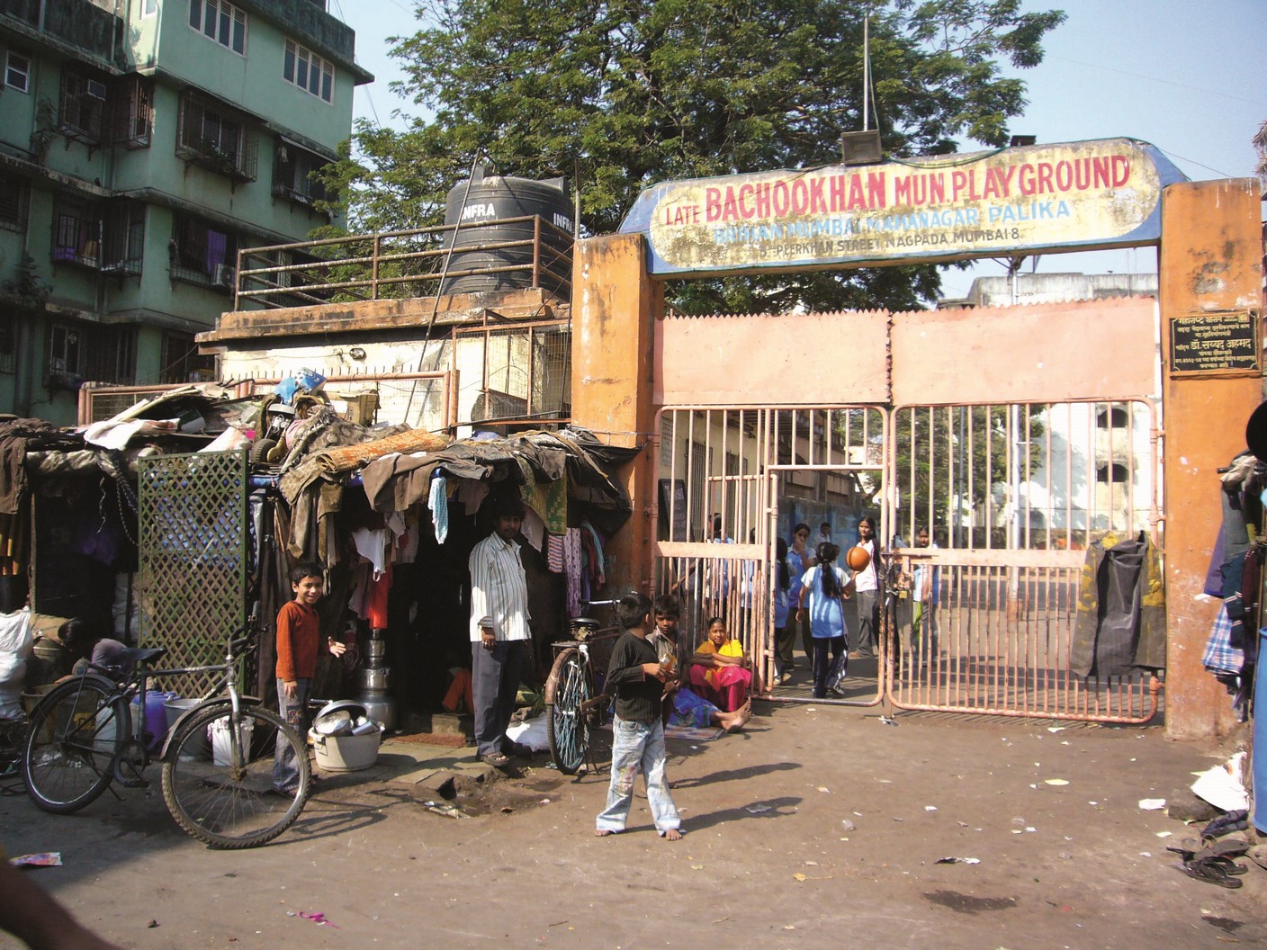 Few children entering a playground from its gate.
