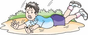 A boy is lying in the ground after falling.