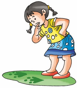 A girl is looking at some footprints on the ground.