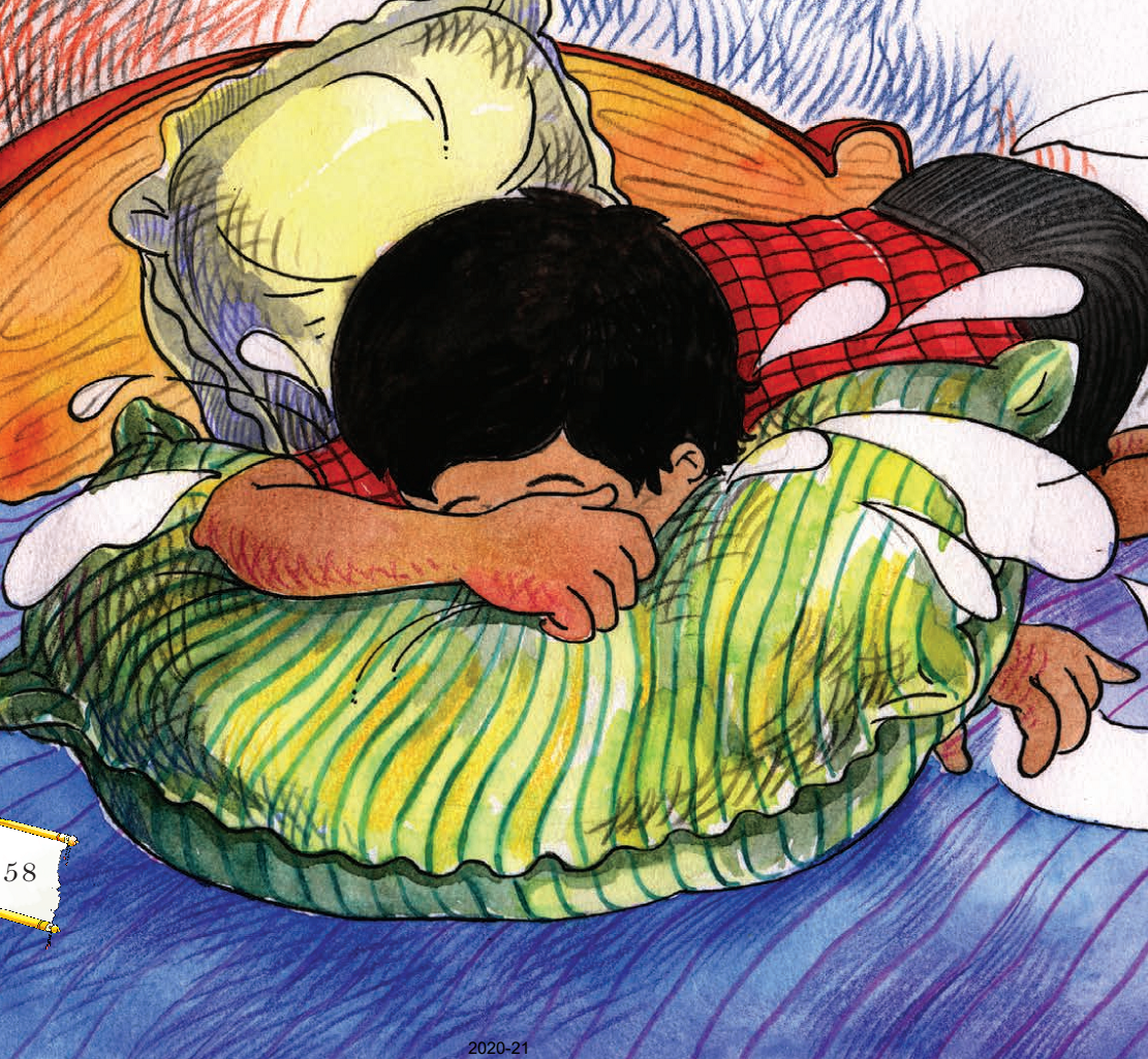 A child crying while hiding his face in a pillow.