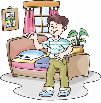 A boy is standing near his bed