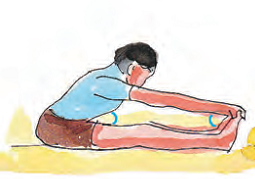 The boy is now sitting on a mat and touching his feet with his hands.