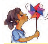 हाथ में पकड़े हुए कागज़ के पंखे पर हवा उड़ाती लड़की।