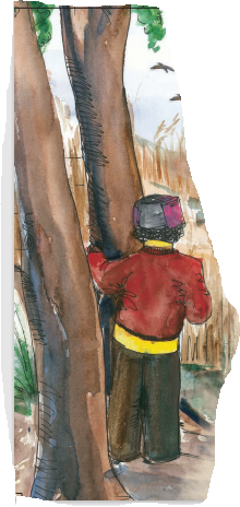 एक लड़का एक पेड़ की टहनी को पकड़े खड़ा  है। 