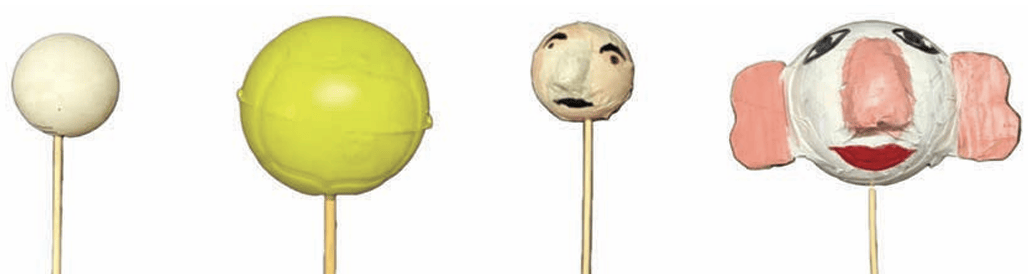 Making ball puppets with nose and eyes made of paper stuck on it and then painted. A broomstick is inserted in the ball for movement.