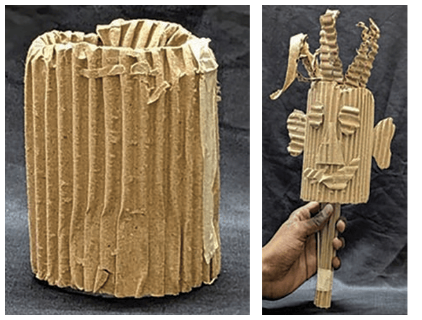 Puppet made of discarded cardboard; eyes, nose, mouth, ears and hair cutout of cardboard and pasted on the body. Multiple broomsticks taped together and inserted into the cardboard section of the puppet to make it move.