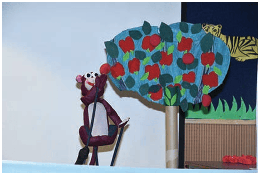 A tree used as a prop to show that a monkey is plucking an apple from the tree. The monkey’s hand is moved using the stick attached to it.