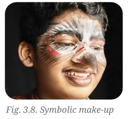 Close-up of an actor with symbolic face paint