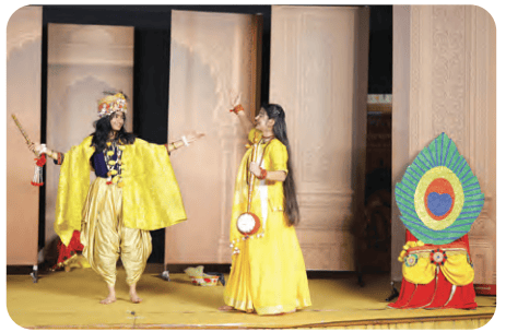 Children in colorful traditional costumes on stage