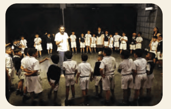 Students and instructor in a circle during a theatre workshop