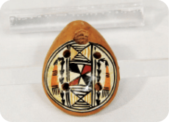 A gold ring with a black and white design is displayed on a white background.  AI generated content