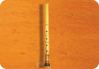 A wooden table with a large wooden instrument on it.  AI generated content